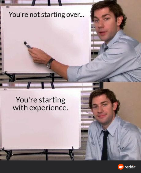 man in a blue shirt and tie holding a white board with a sign that says you ' re not starting over you ' re starting with experience