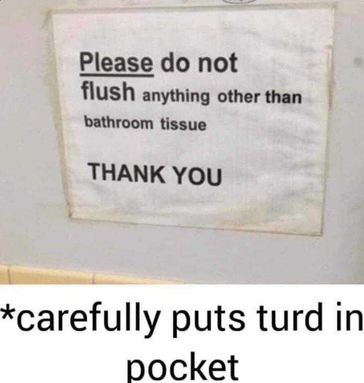 a close up of a sign on a wall with a toilet in the background