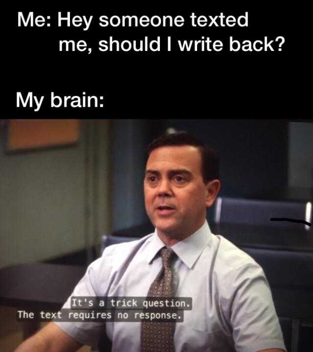 man in a tie sitting at a desk with a text message