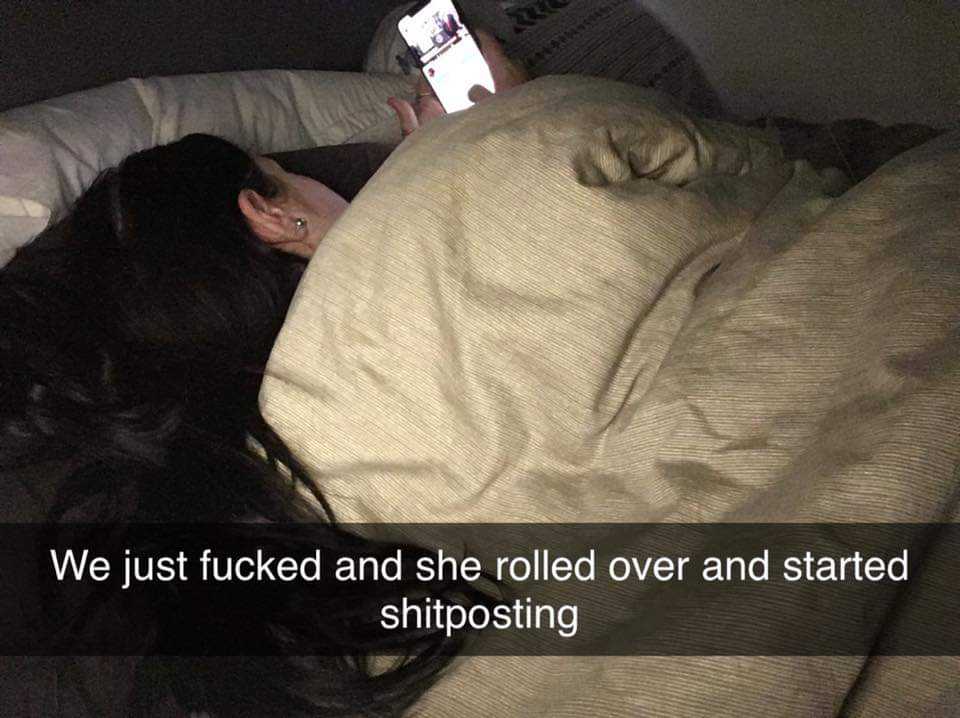 woman laying in bed with a cell phone in her hand