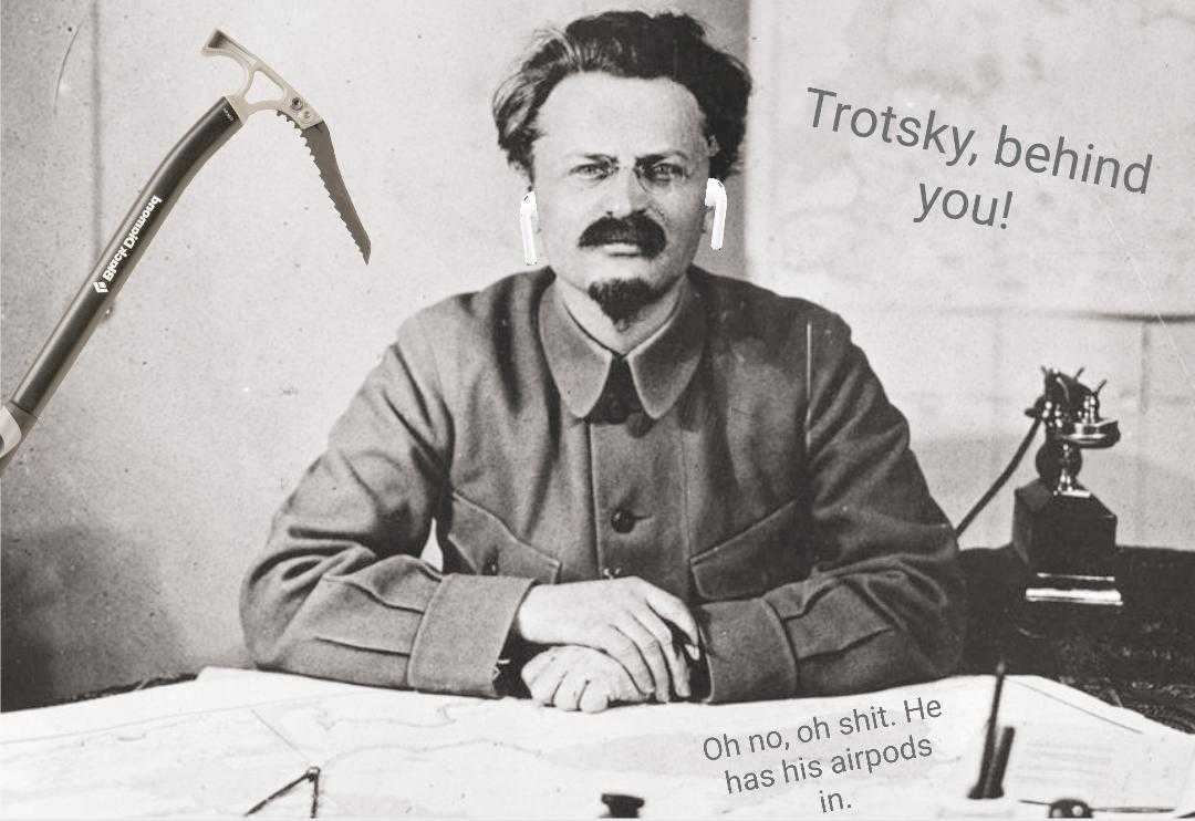 man sitting at a desk with a hammer and a sign