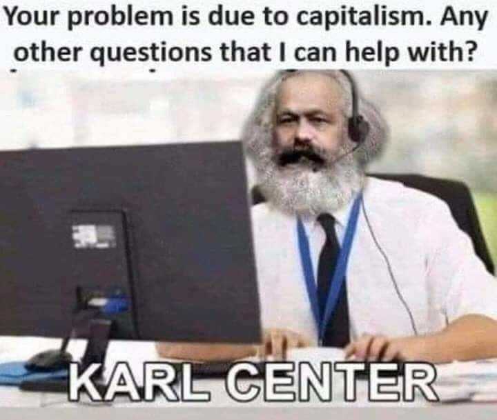 man sitting at a desk with a computer and a caption that reads, your problem is due to capitalism any other questions that can help with?