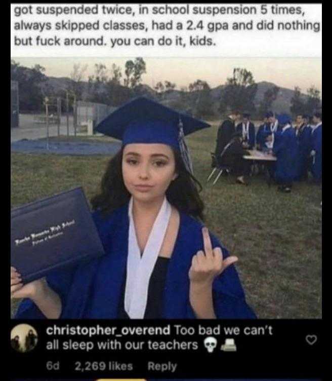 a woman in a graduation gown holding a diploma and giving the peace sign