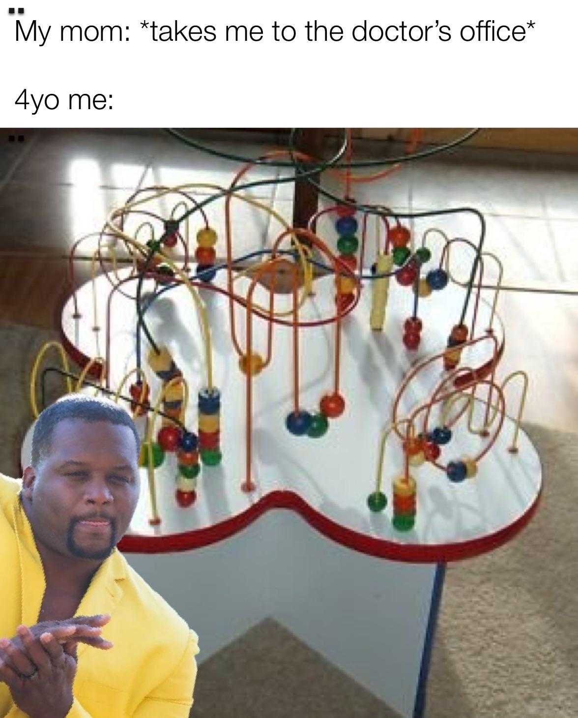 man in yellow shirt pointing at a toy tree