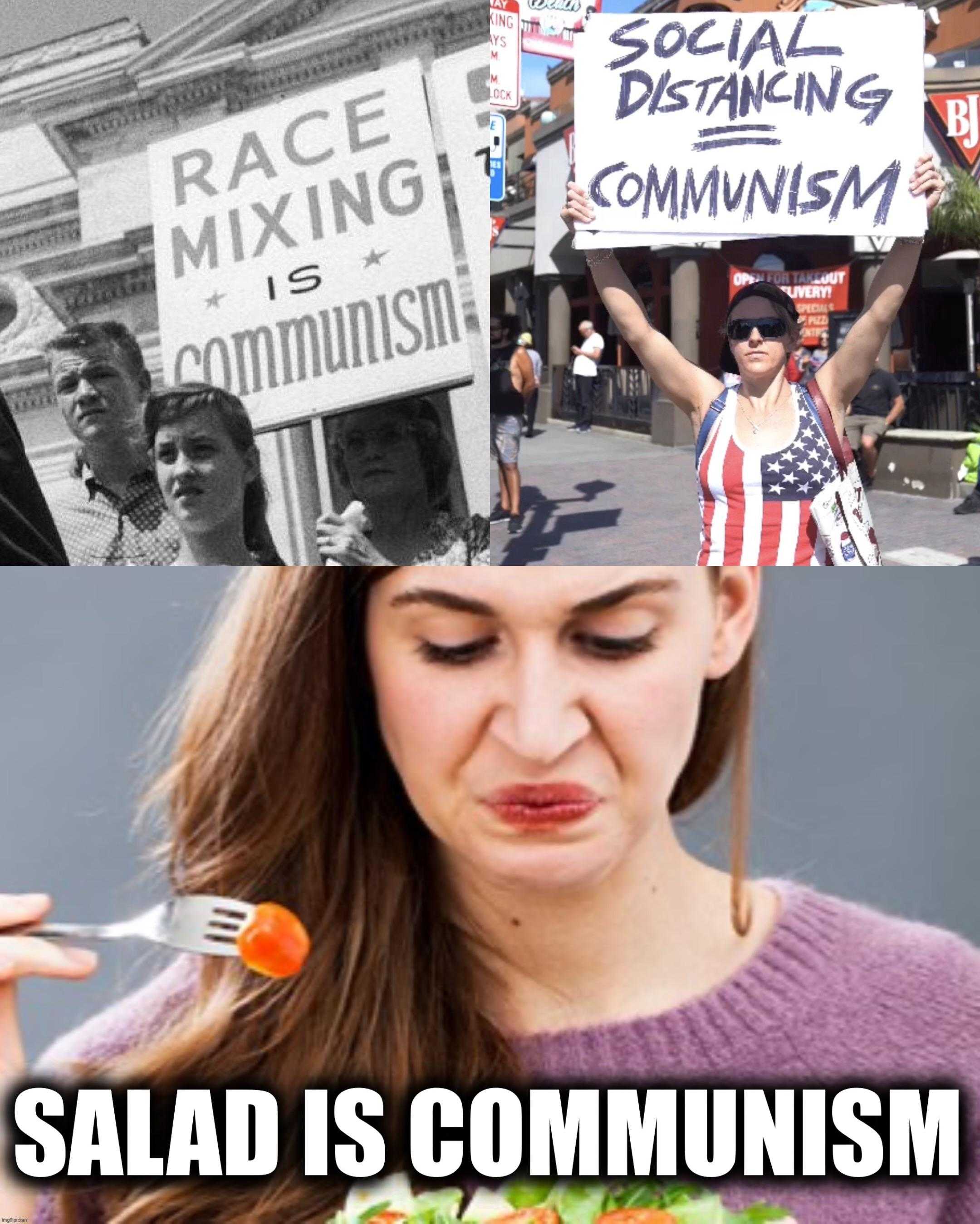 woman eating a salad and a man holding a sign