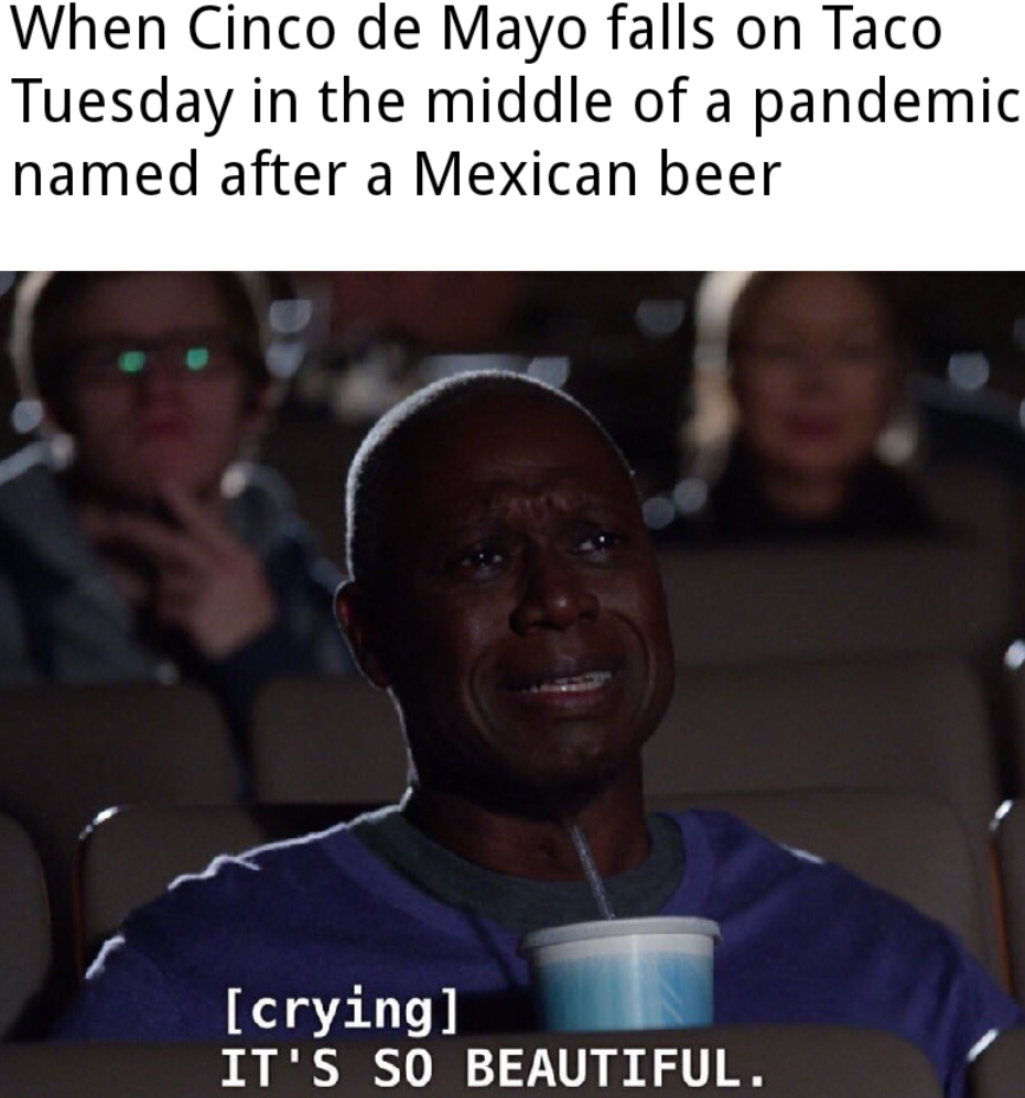 man in a movie theater drinking a drink