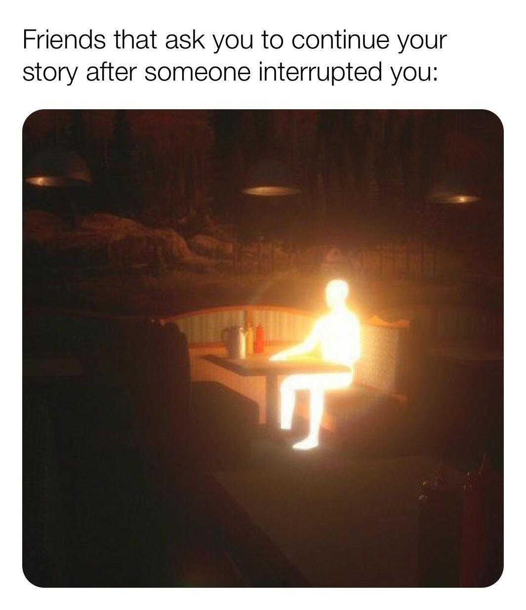 someone sitting on a bench with a lit candle in the dark