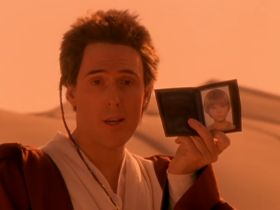 man holding a picture of himself in a desert