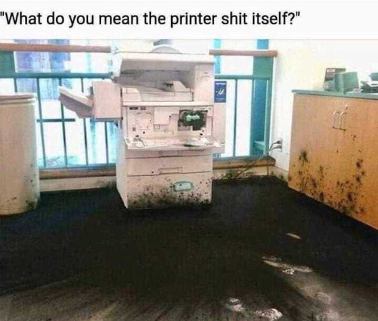 printer sitting on top of a dirty floor in a room