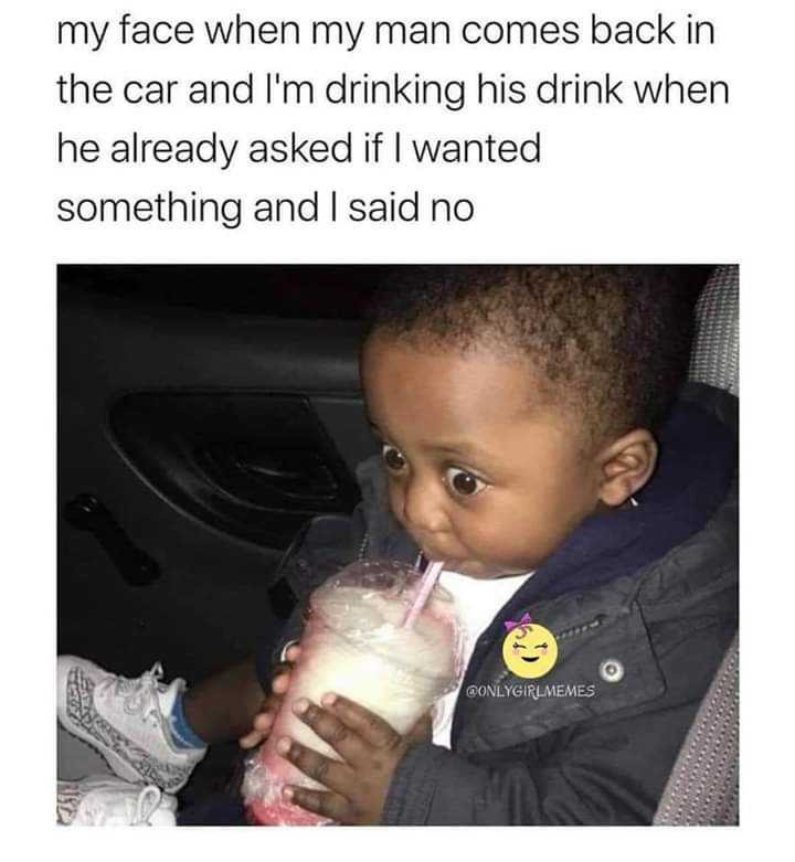 a close up of a child drinking milk from a plastic cup