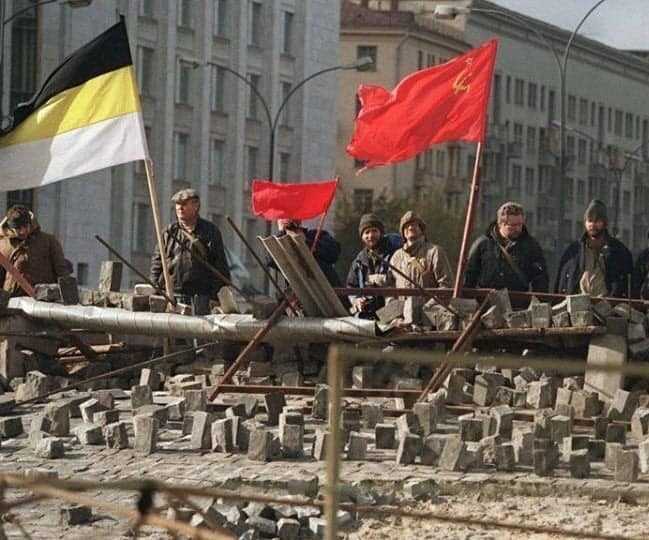 soldiers stand in front of a building with flags and bricks