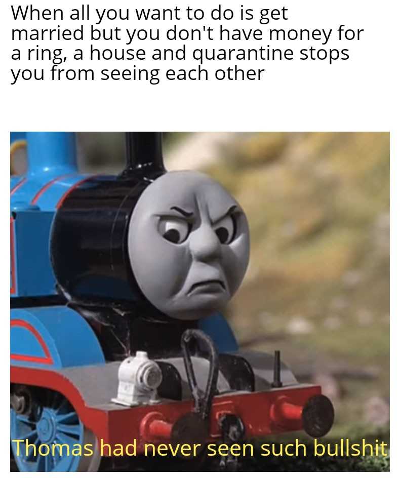 thomas the train is sitting on the tracks with a sad face