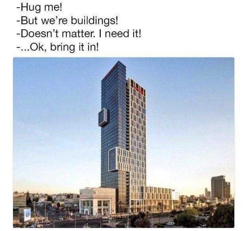 building with a sign that says, hug me building doesn ' t matter, i need it