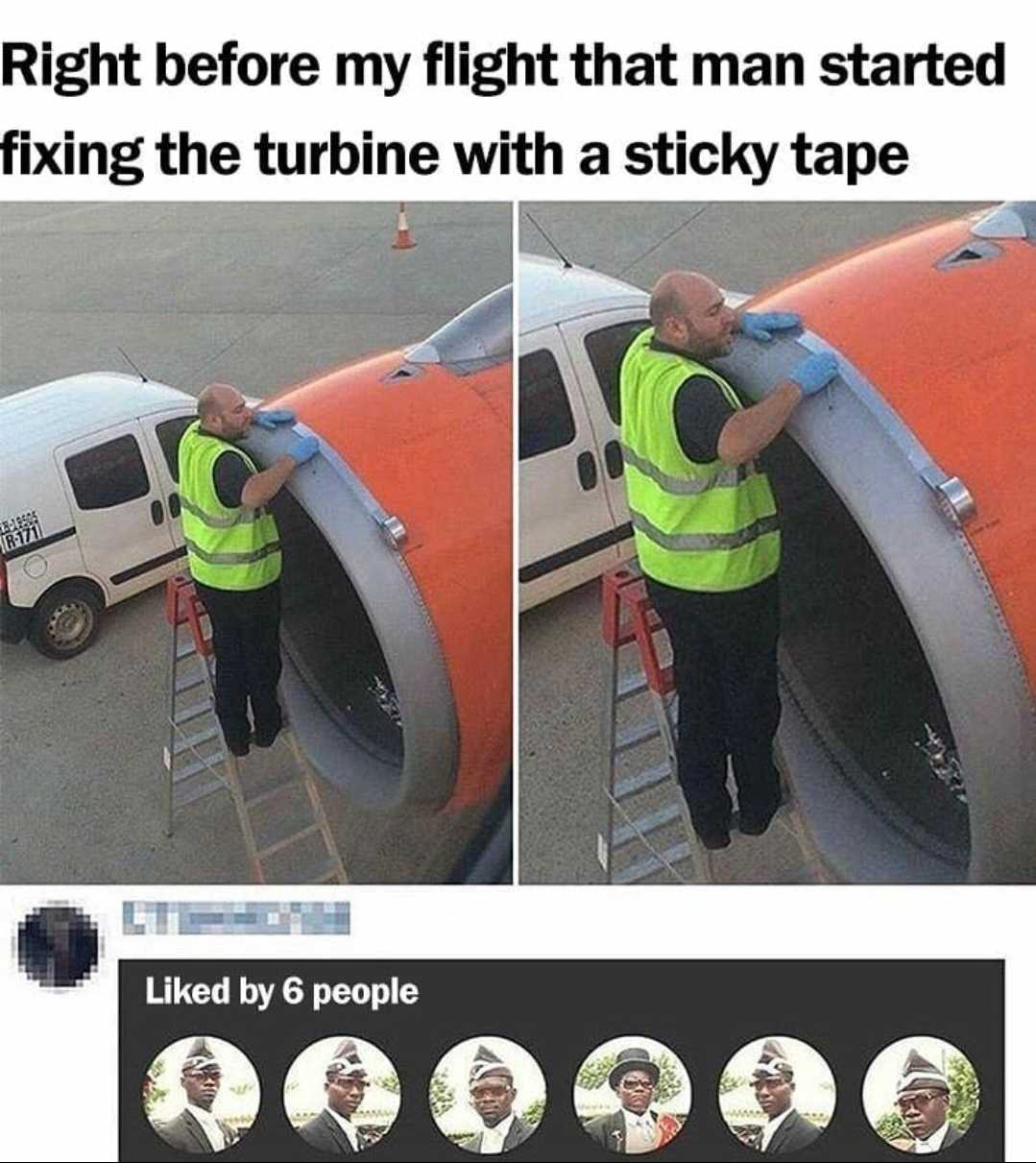 man in safety vest standing on ladder next to airplane