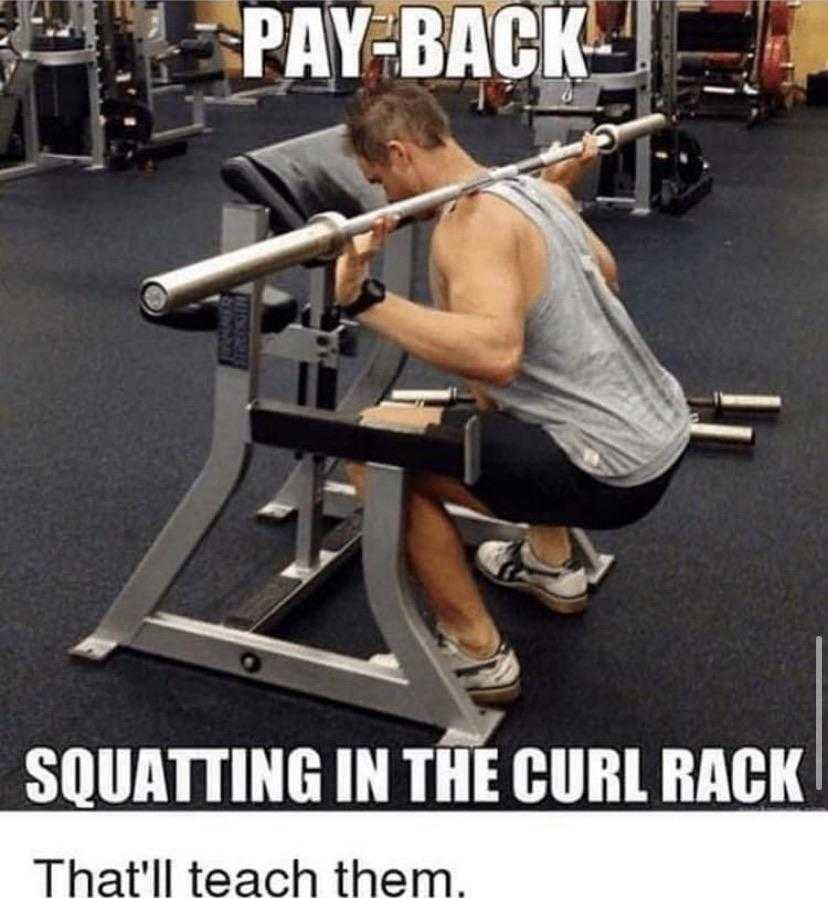 man squatting in the curl rack in a gym