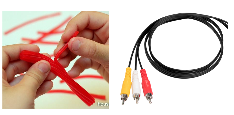 a close up of a person holding a red and yellow cable