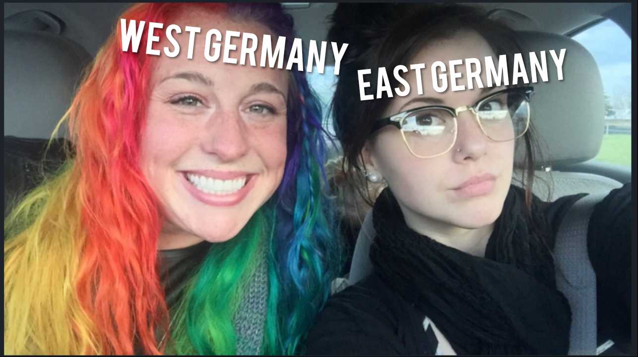 two women with colorful hair and glasses are smiling for the camera