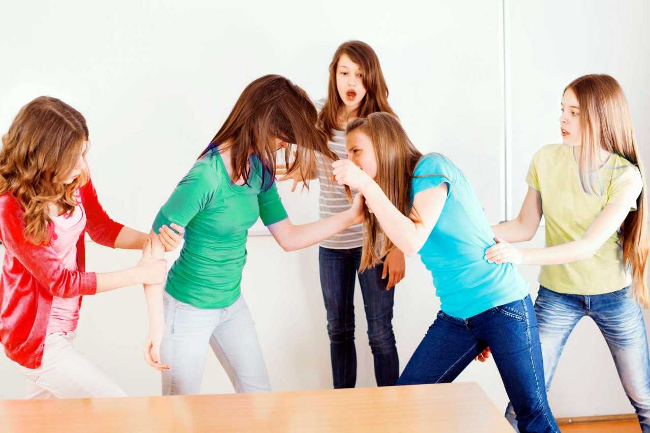 several girls are playing with each other in a room