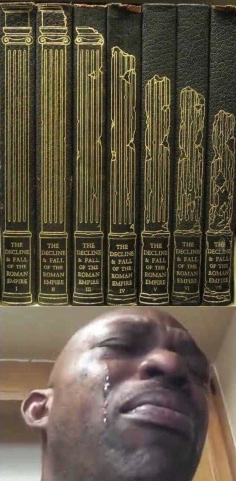 man with a tear on his face in front of a row of books