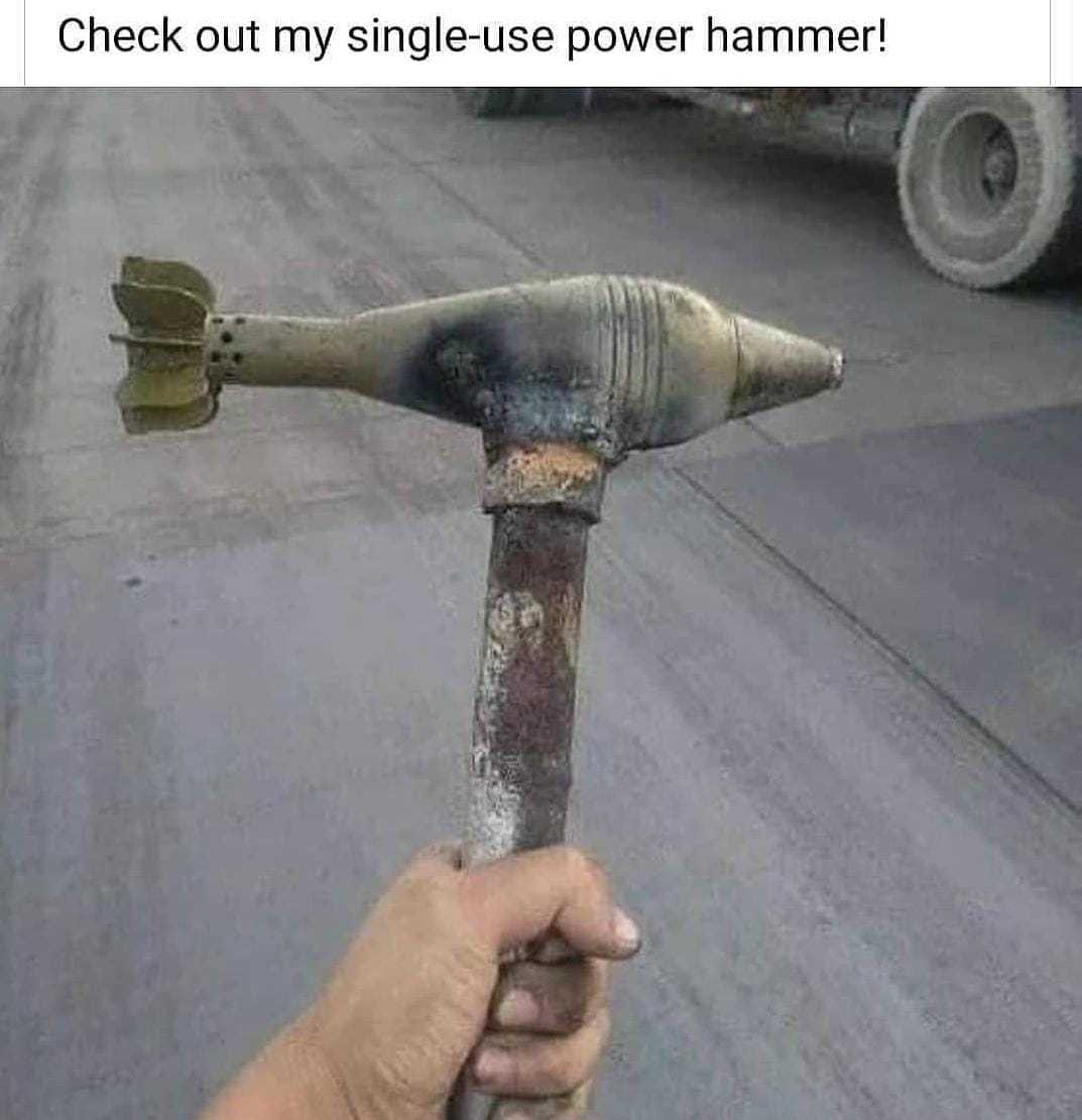 someone holding a hammer with a piece of metal sticking out of it