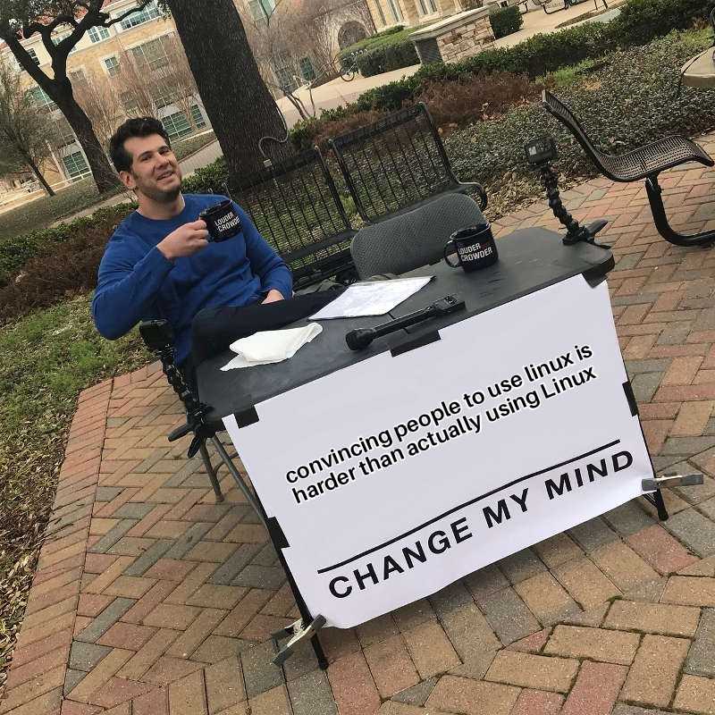 man sitting at a table with a sign on it