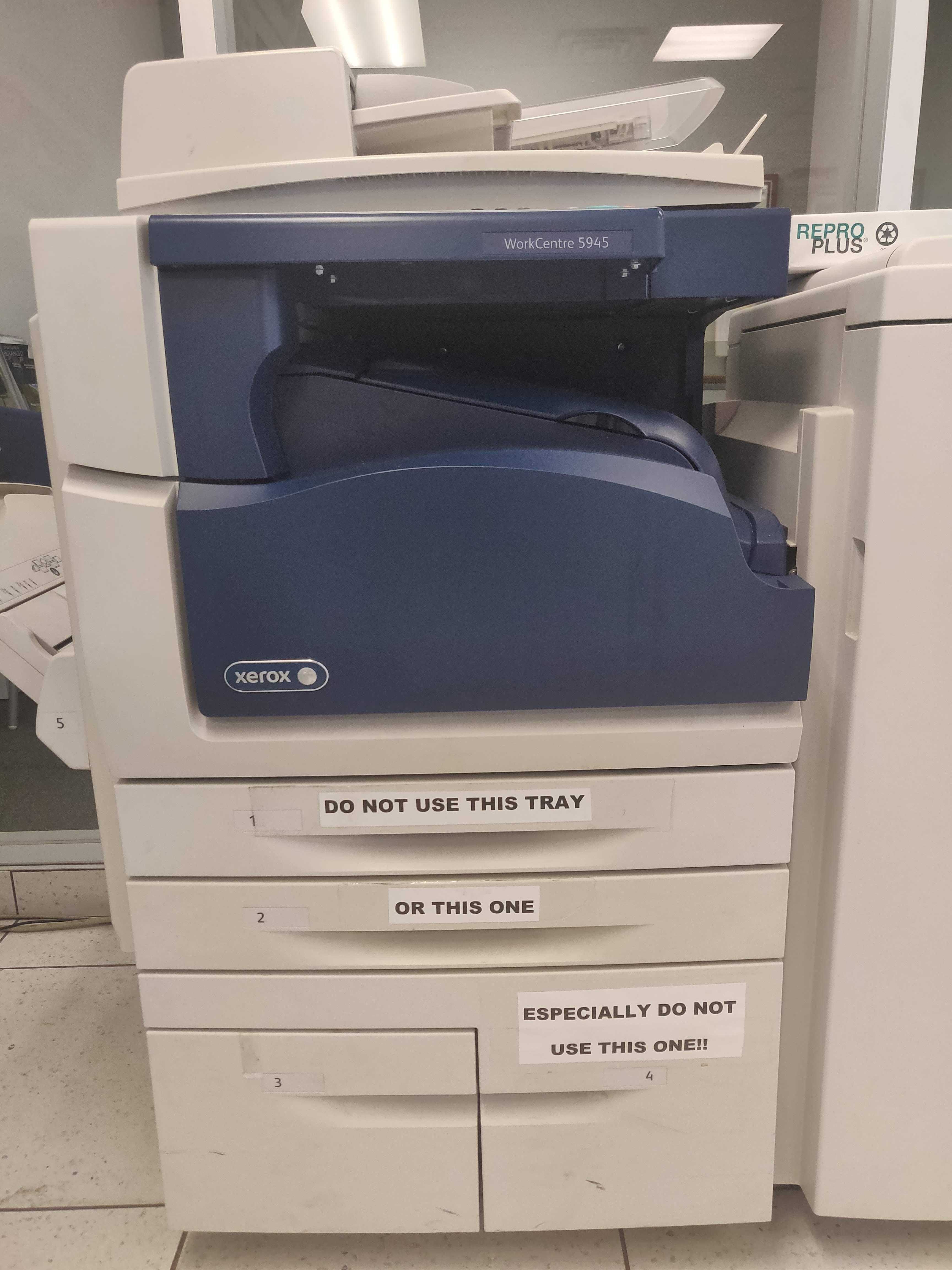 a close up of a printer with a lot of paper on it