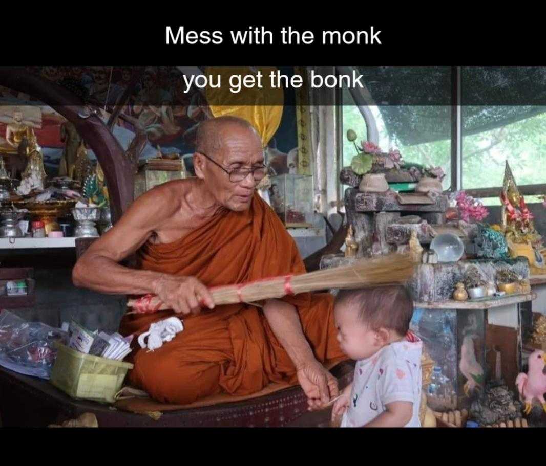 monk sitting in a boat with a child in front of him