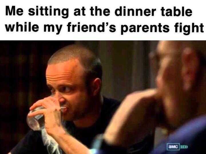 man drinking from a glass while sitting at the dinner table while my friend ' s parents fight