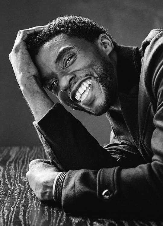 man with a beard and a smile on a table