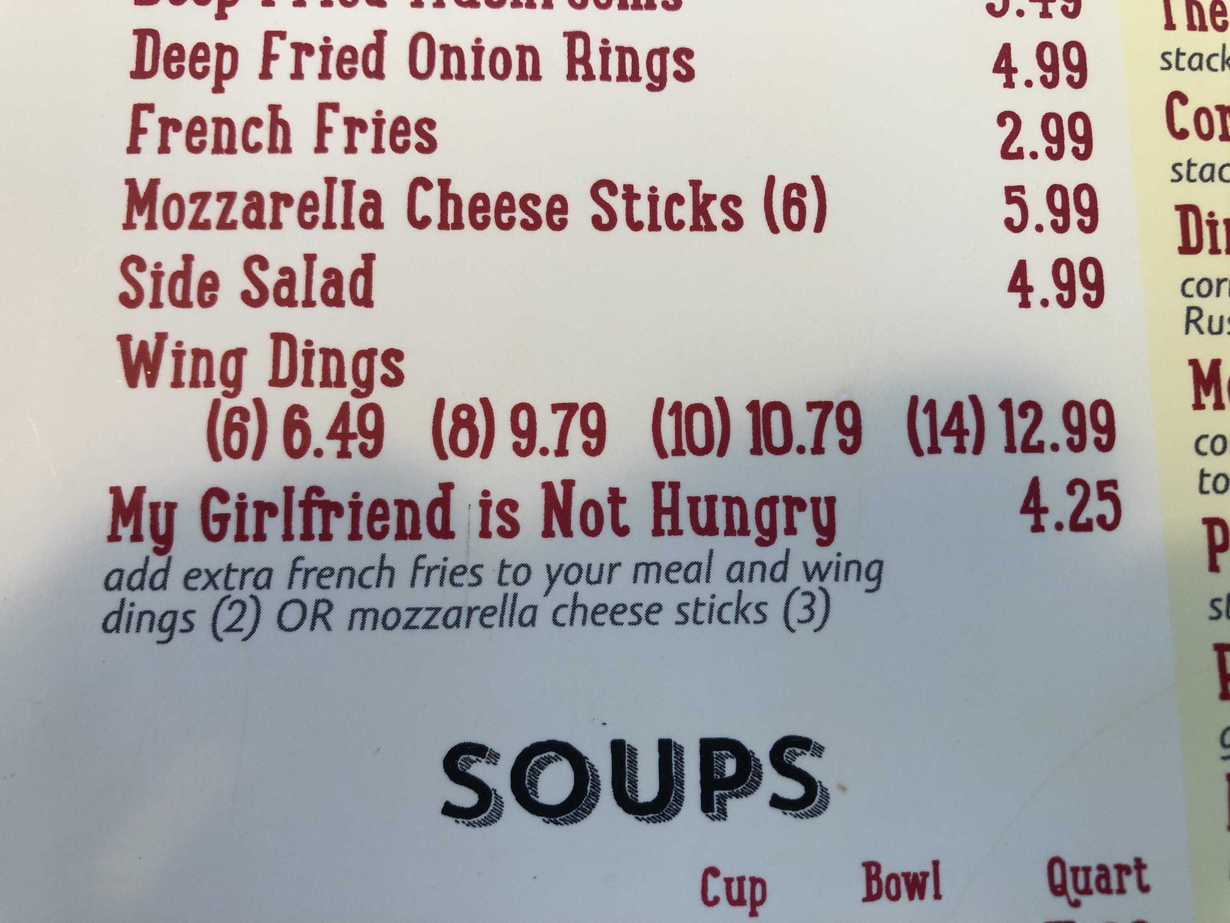 a close up of a menu for soups on a table