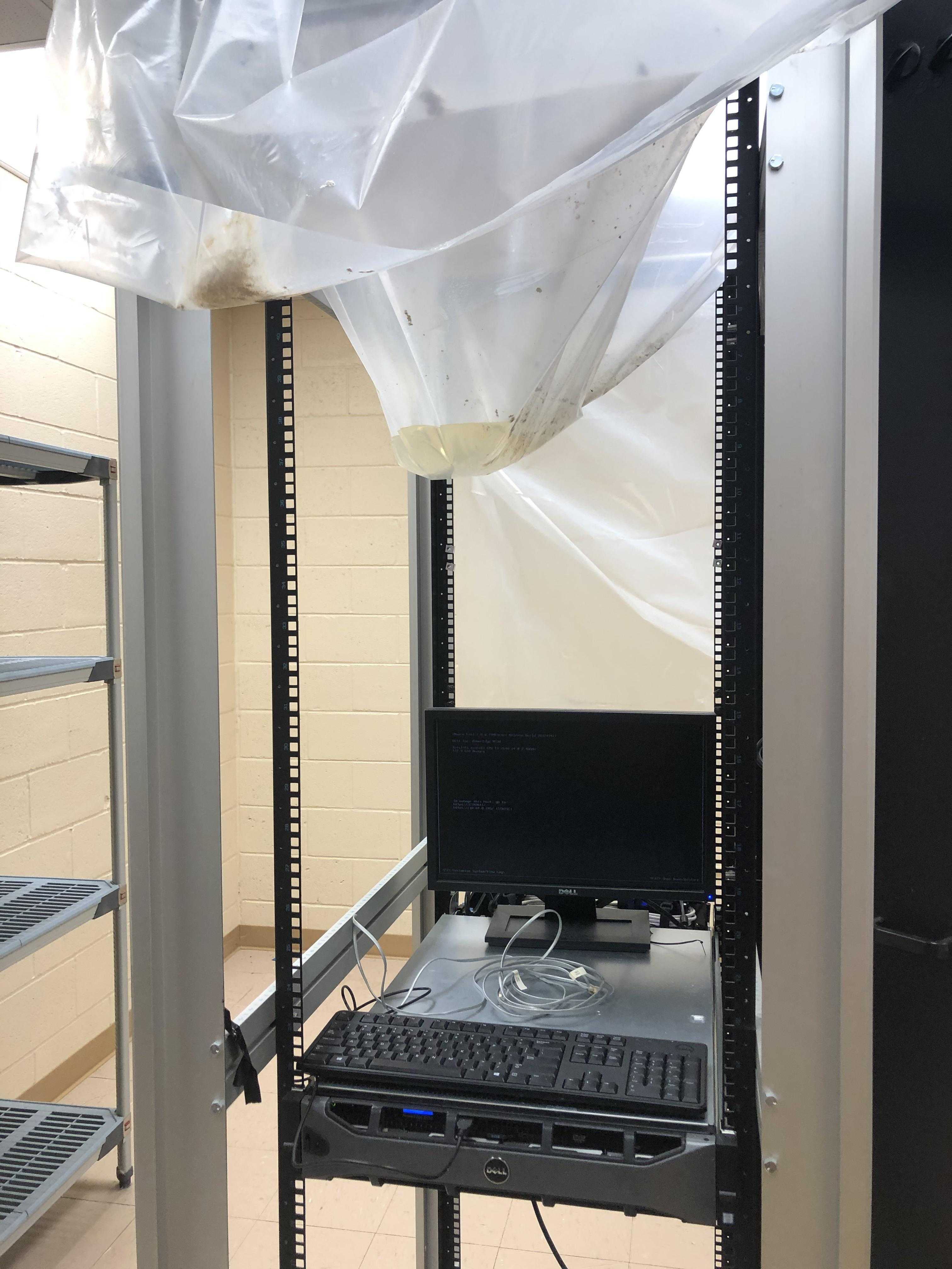 there is a computer on a rack in a room with a white sheet covering it