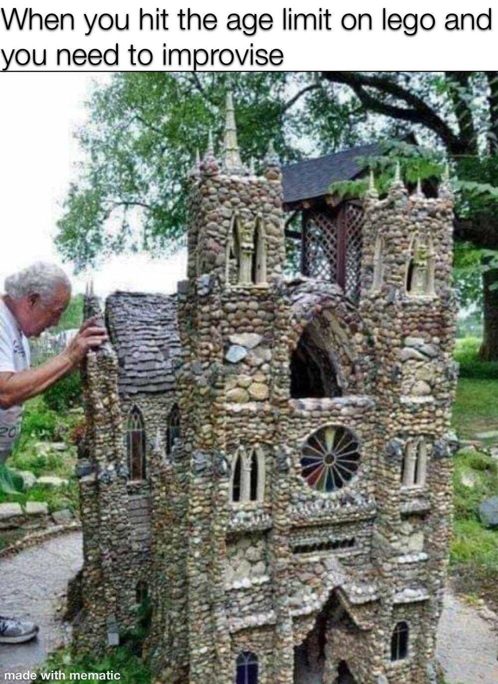 man standing in front of a castle made of rocks