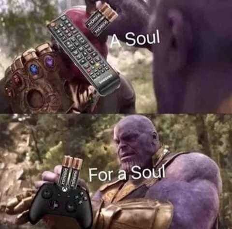 thanos holding a remote control and a cell phone with the caption of a soul for a soul