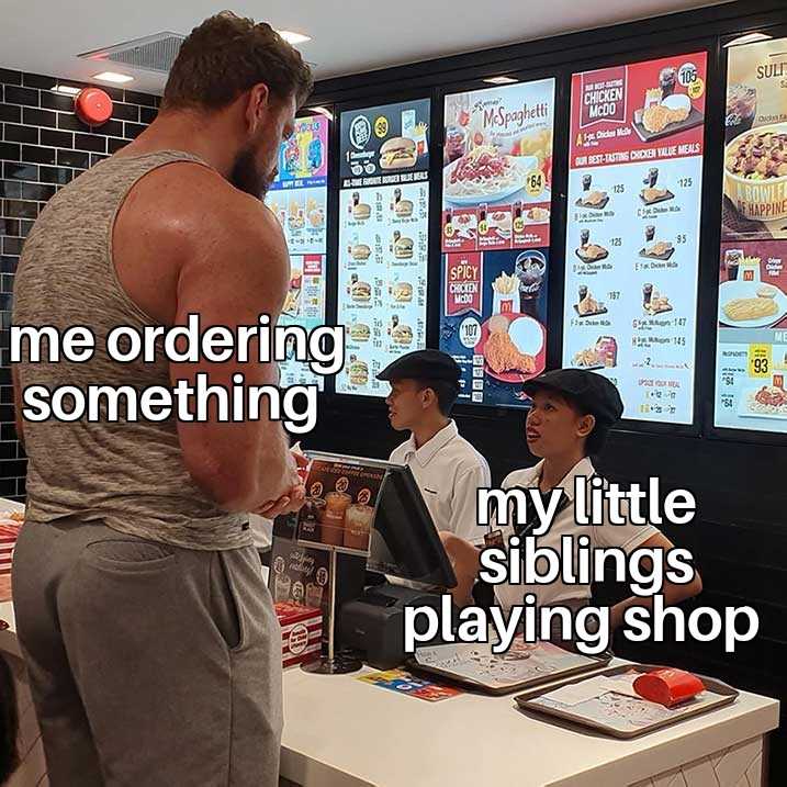 there is a man standing in front of a counter with a laptop