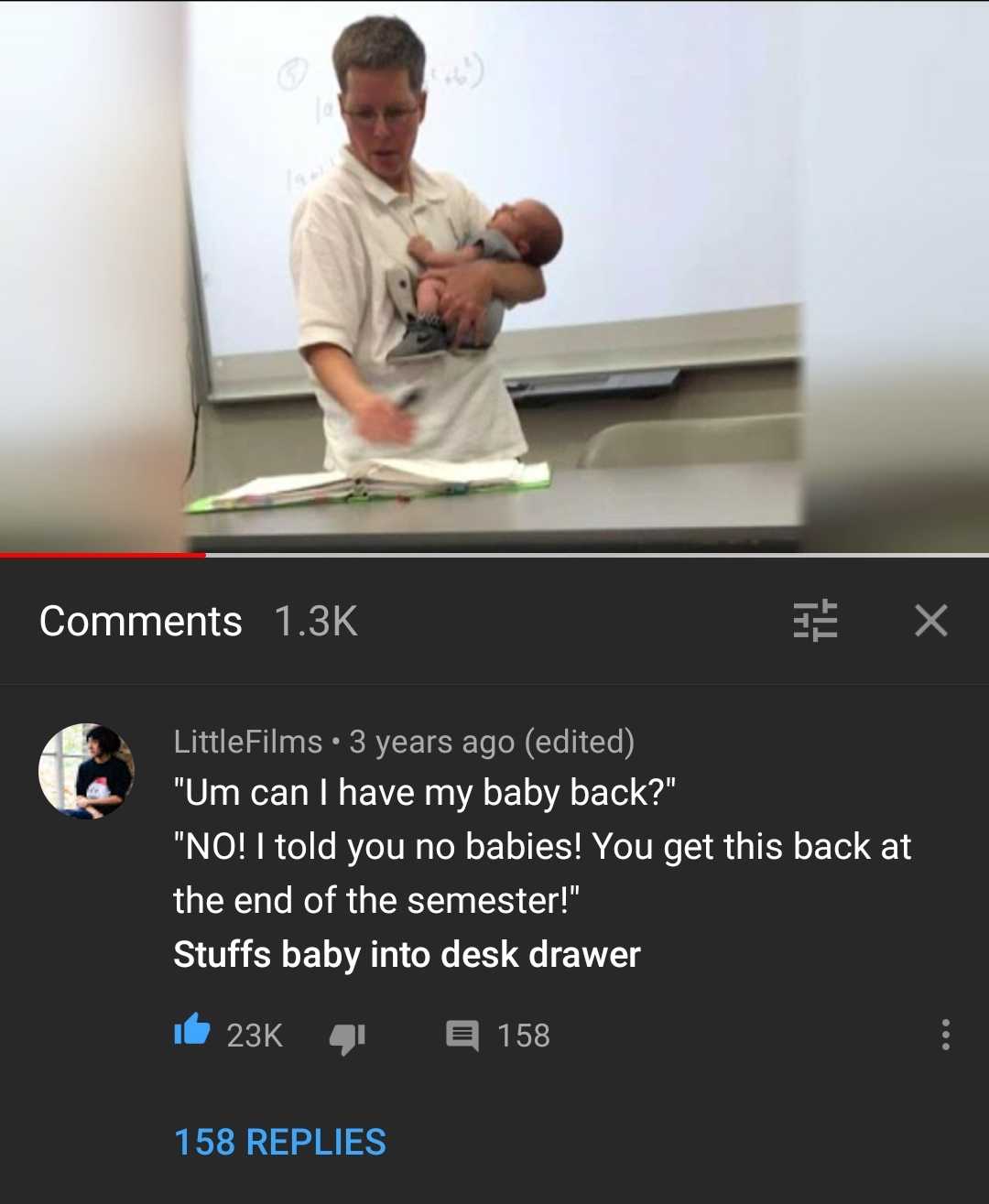 someone is holding a baby in a kitchen with a white board