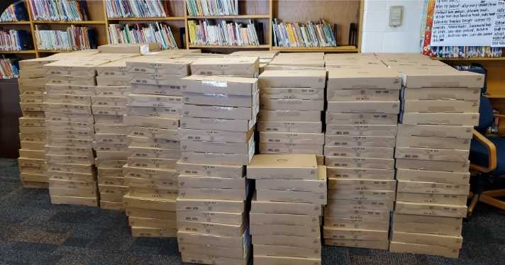 boxes of books stacked on top of each other in a library