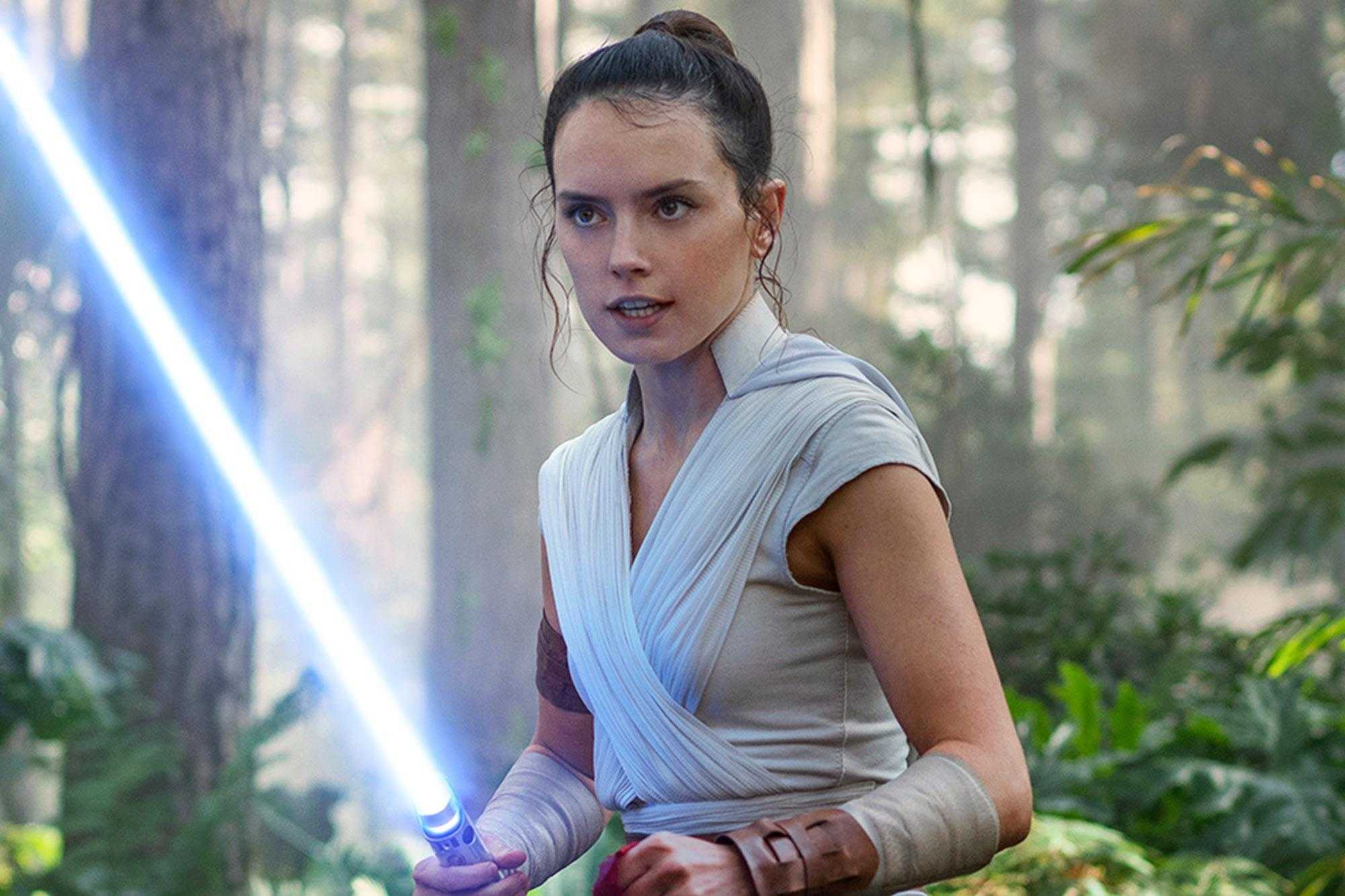 woman in a white dress holding a light saber in a forest