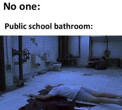 person laying on the floor in a public school bathroom