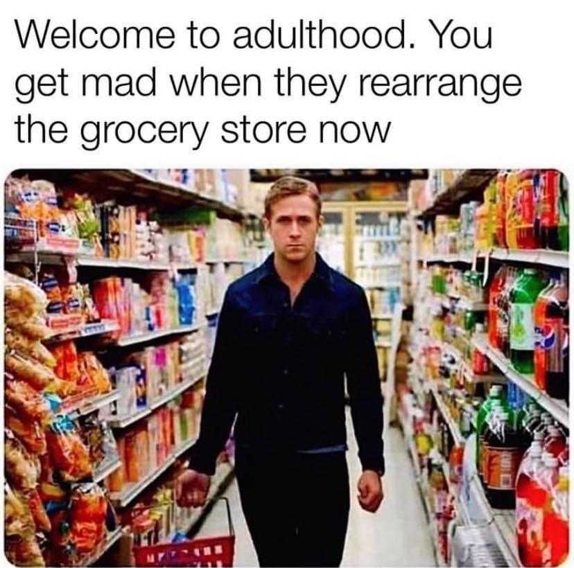 man in a grocery store with a shopping cart