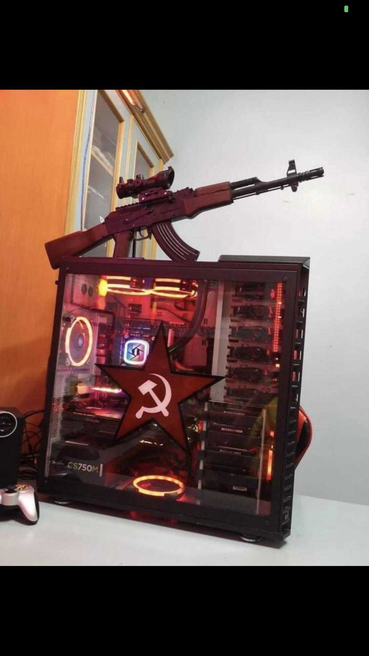 there is a computer case with a gun on top of it