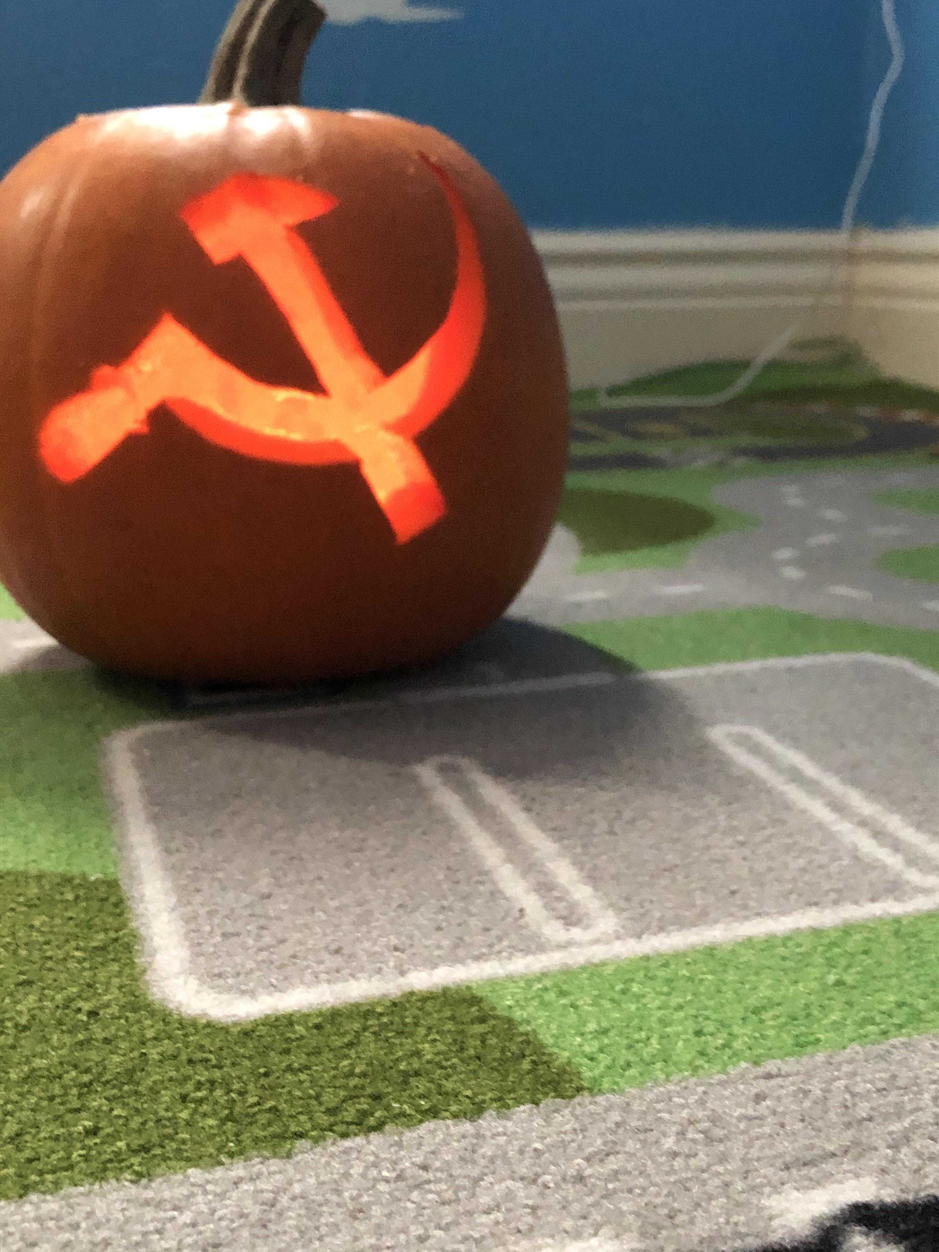 pumpkin with hammer and sickle symbol carved into it