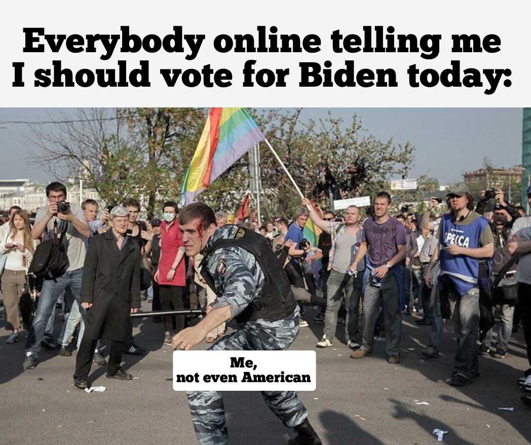 there is a man holding a rainbow flag in front of a crowd