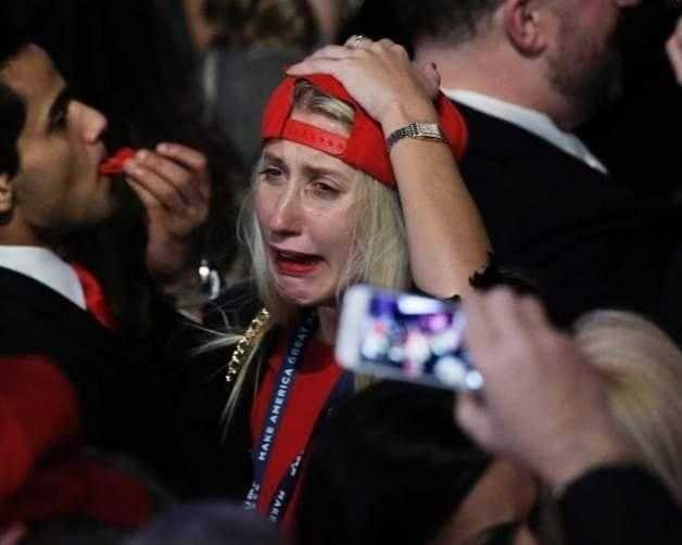 araffe woman in red hat and red bandana at a political event