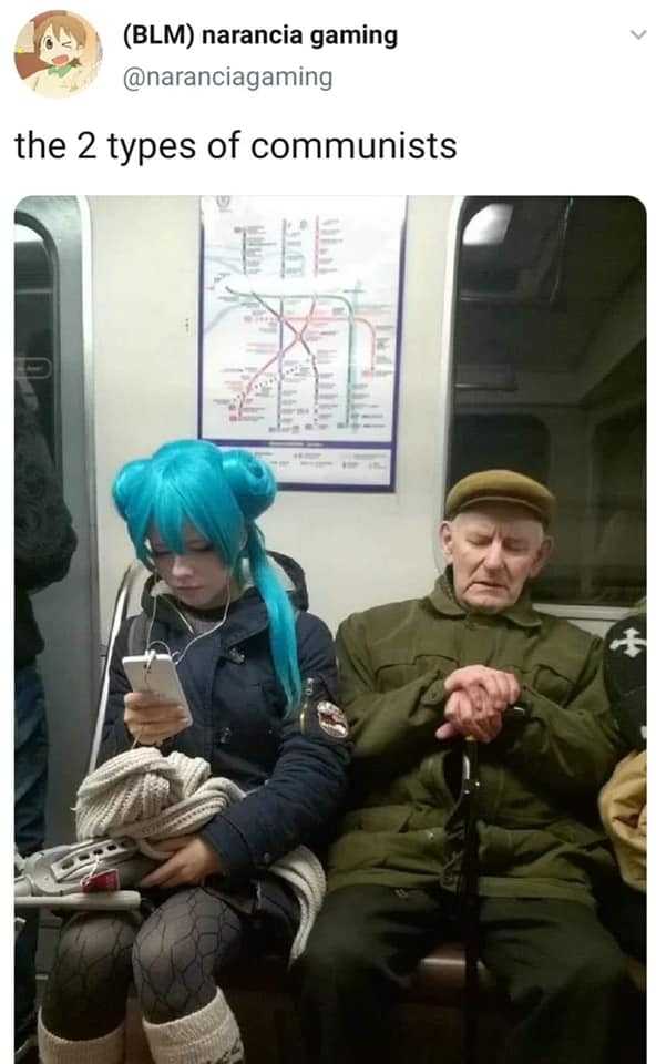 man with blue hair sitting on a subway with a woman in a blue wig