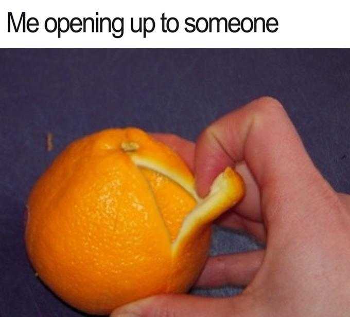 someone is peeling an orange with their fingers and holding it