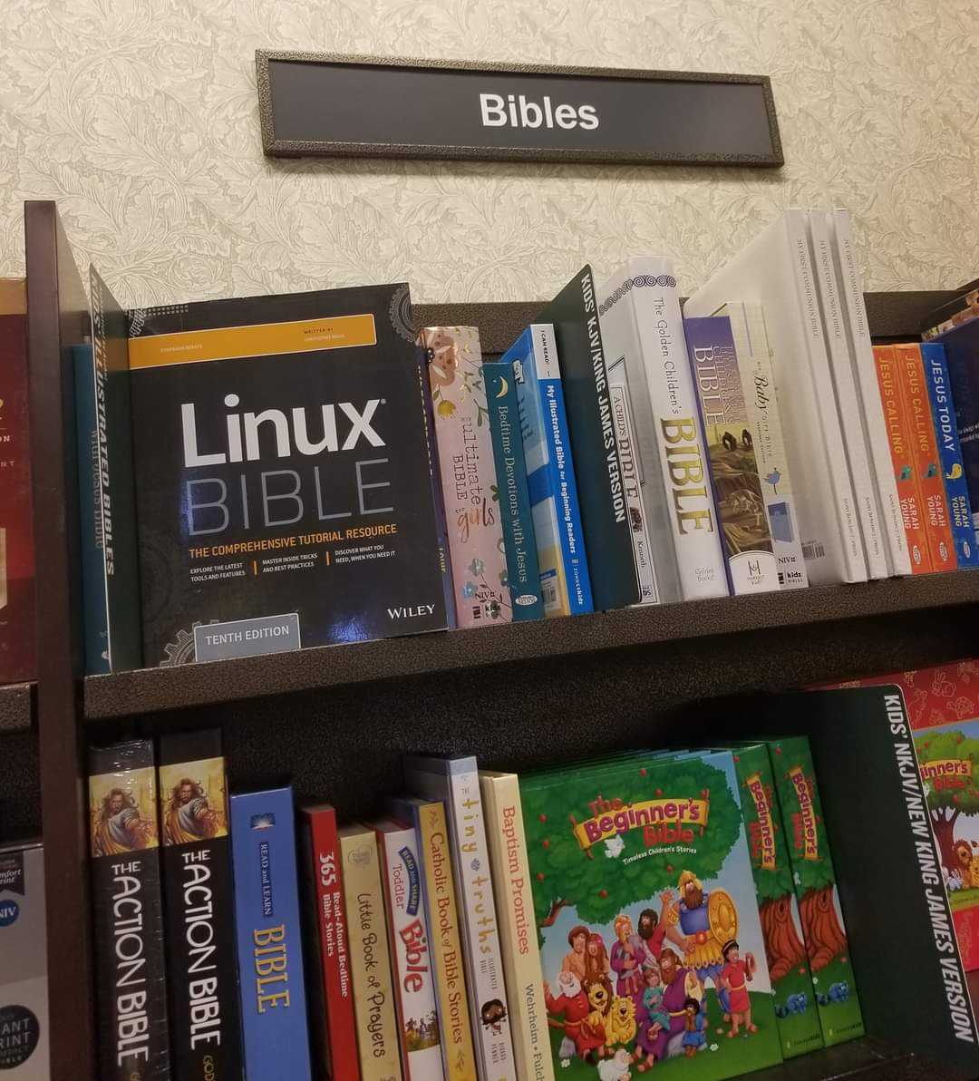 books on a shelf in a library with a sign above it