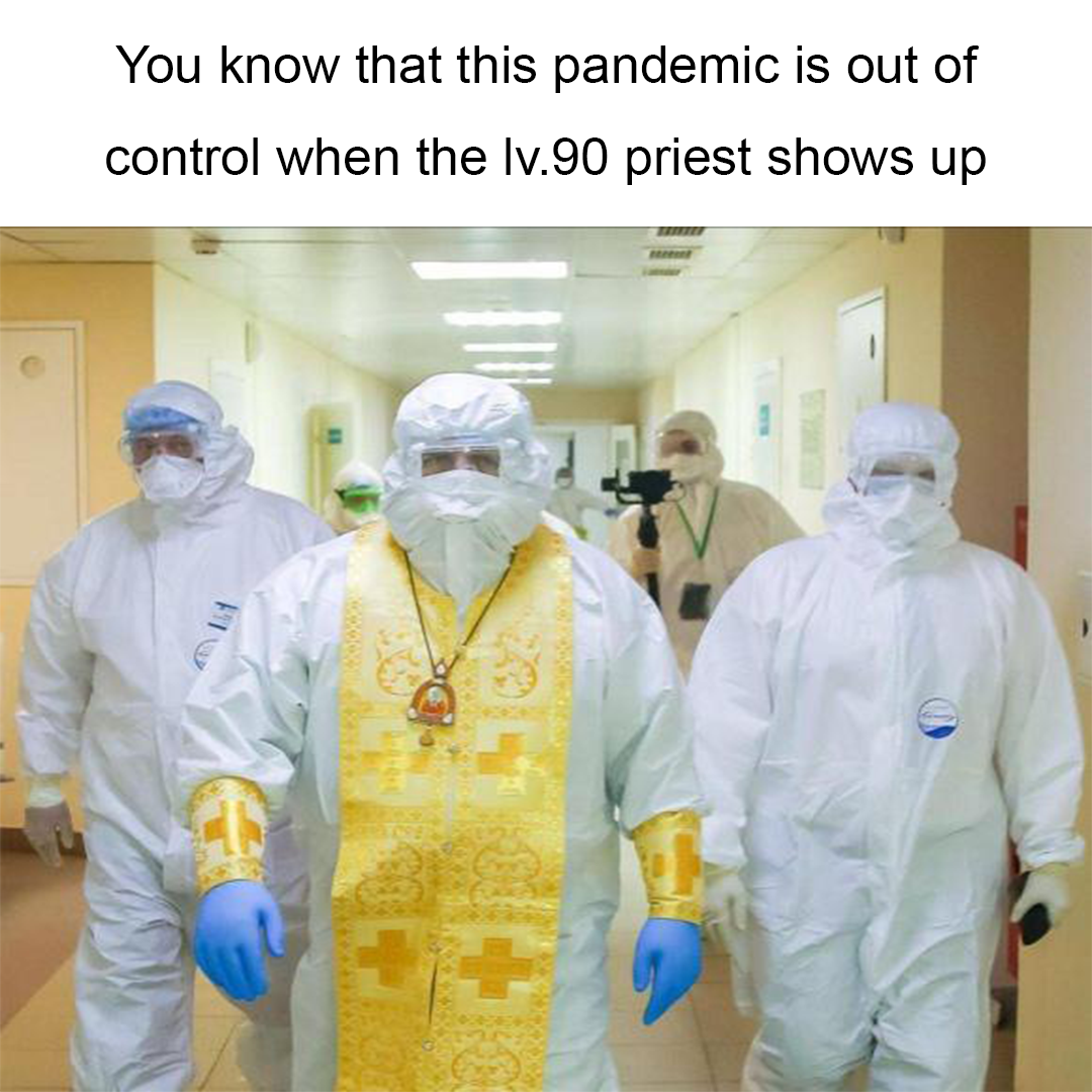 three people in protective gear walking down a hospital hallway