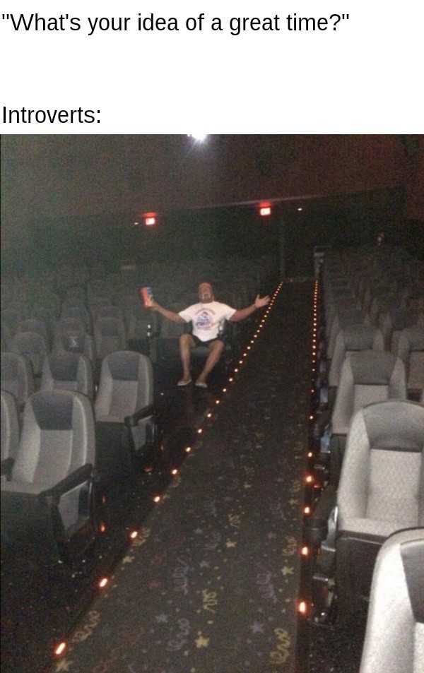 man sitting in a theater with his arms outstretched