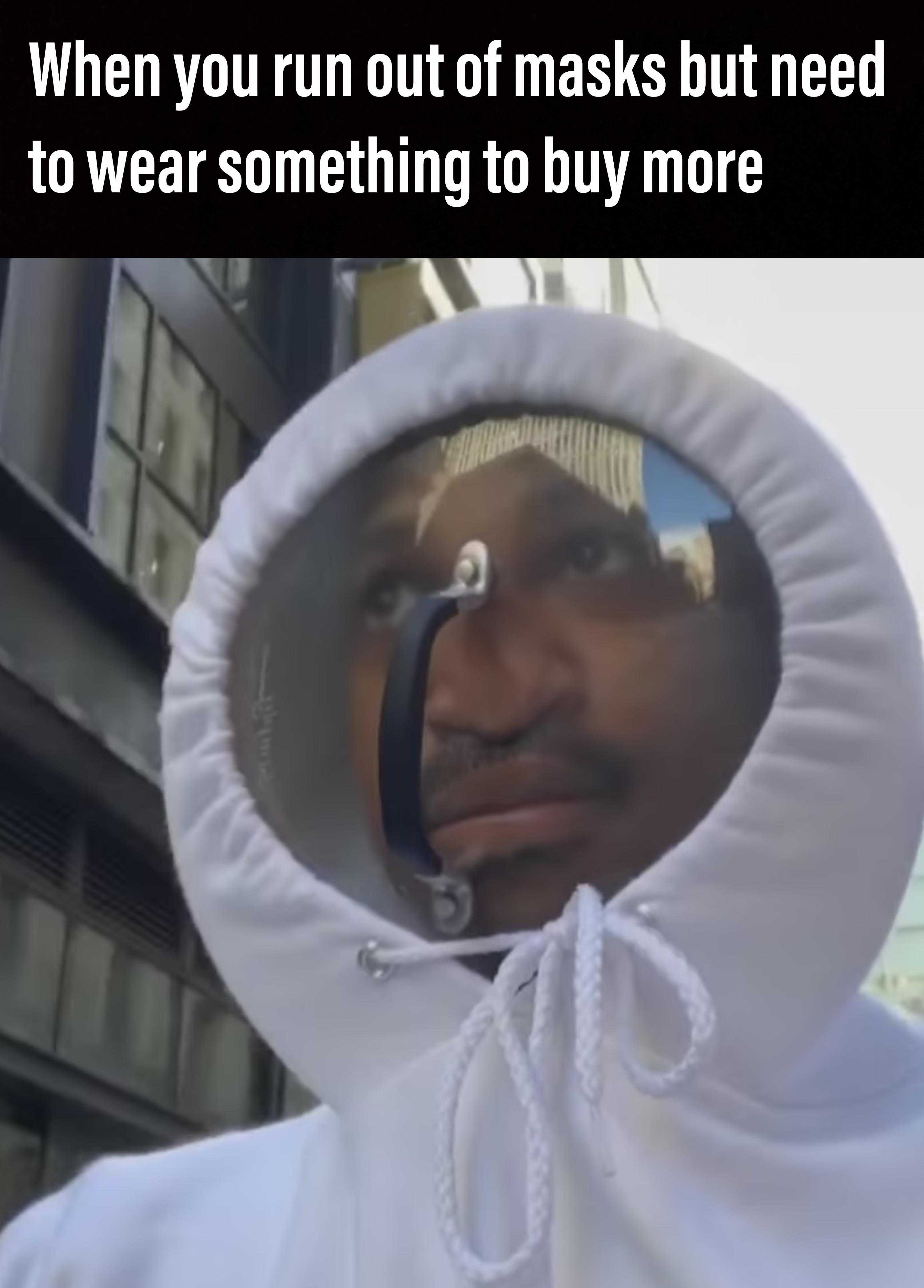 man in a white hoodie with a phone in his mouth