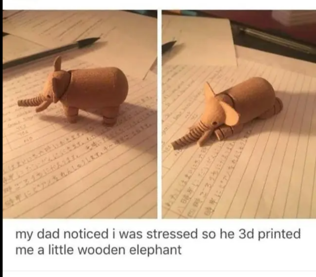 a close up of a wooden elephant on a piece of paper